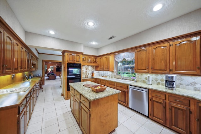 kitchen featuring stainless steel dishwasher, backsplash, a center island, double oven, and sink