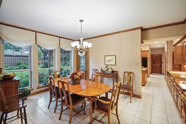 dining room featuring a textured ceiling, an inviting chandelier, light tile patterned floors, and ornamental molding