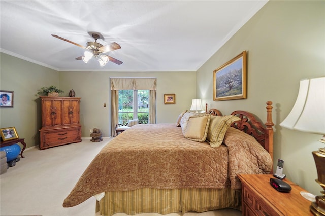 carpeted bedroom with ceiling fan and ornamental molding