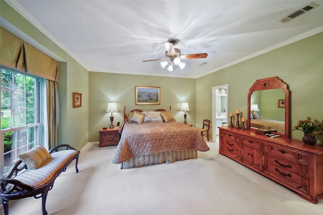 carpeted bedroom featuring ceiling fan and crown molding