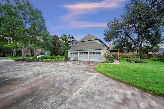 property exterior at dusk featuring a garage and a lawn