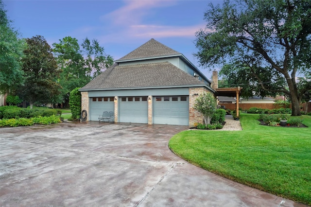 property exterior at dusk featuring a garage and a yard