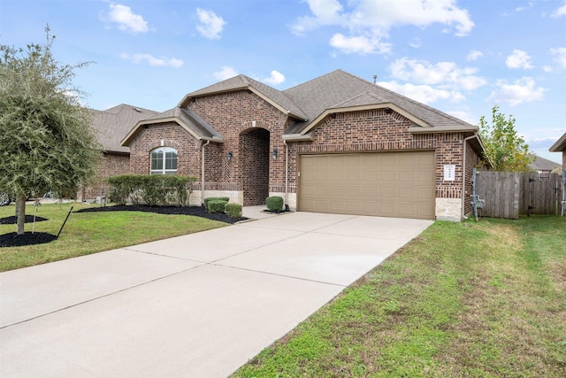 view of front of home with a front yard and a garage