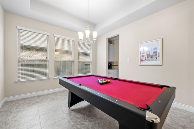 recreation room featuring a notable chandelier, pool table, and a tray ceiling