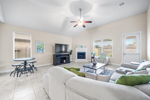 living room featuring ceiling fan, light tile patterned floors, and lofted ceiling