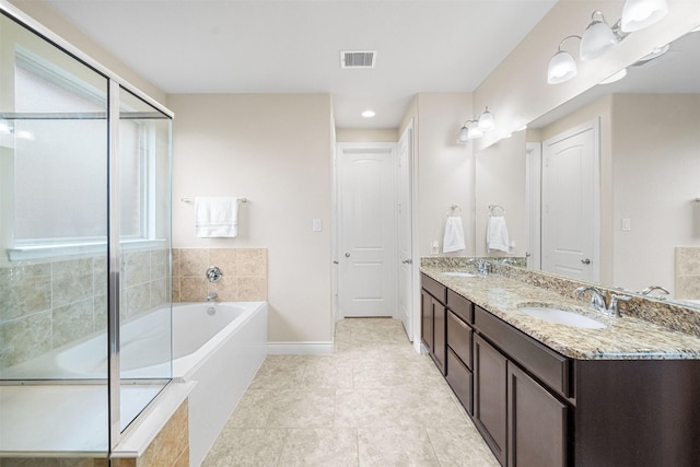 bathroom with shower with separate bathtub, vanity, and tile patterned floors