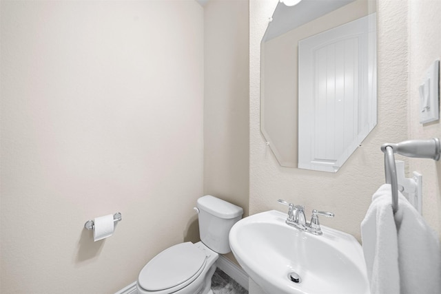 bathroom with toilet and sink