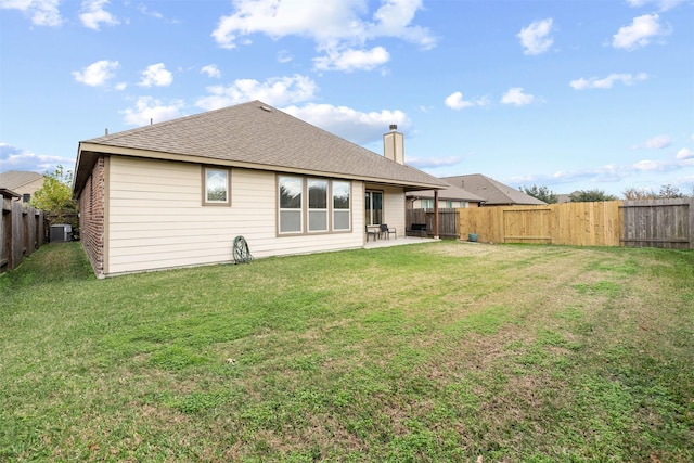 back of property featuring a lawn, a patio, and central AC