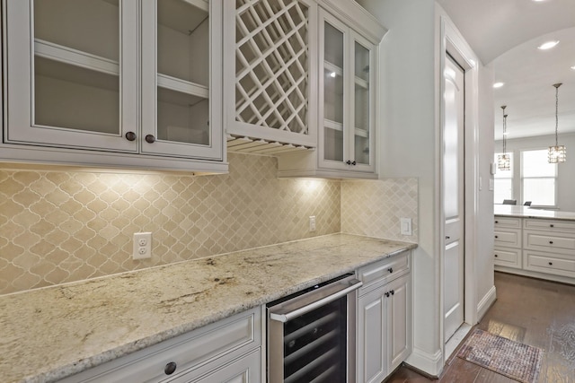 kitchen with wine cooler, dark wood-type flooring, white cabinets, and hanging light fixtures