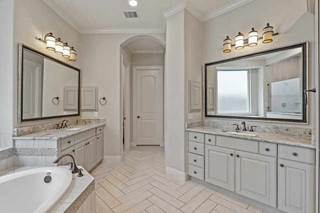 bathroom with vanity, a relaxing tiled tub, and ornamental molding