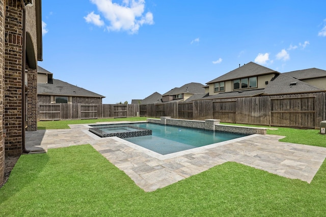 view of pool featuring a lawn, a patio area, and an in ground hot tub