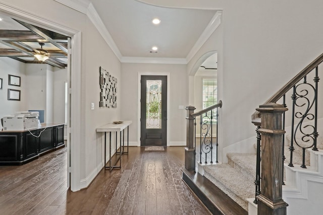 entryway with beam ceiling, crown molding, dark wood-type flooring, and coffered ceiling