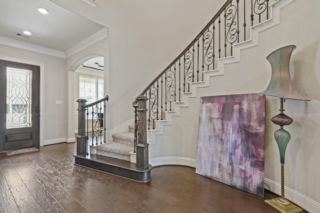 foyer with dark hardwood / wood-style flooring and ornamental molding