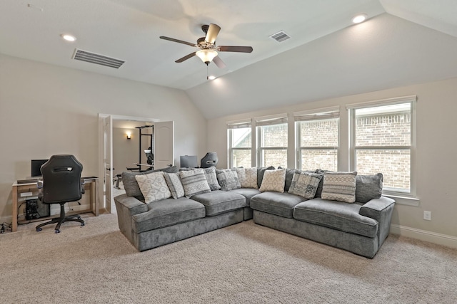 carpeted living room with ceiling fan and vaulted ceiling