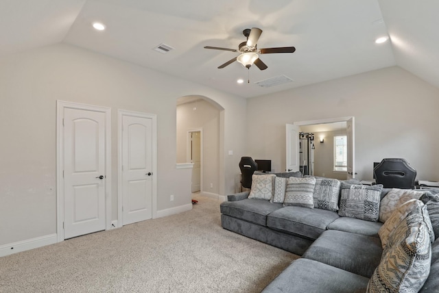 living room featuring carpet flooring, vaulted ceiling, and ceiling fan