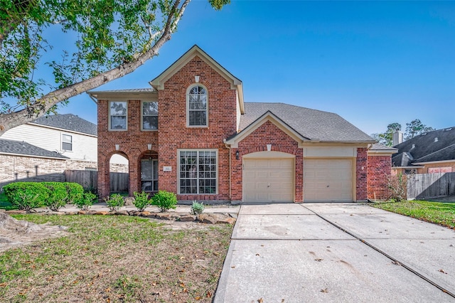 view of front of home featuring a garage, fence, brick siding, and driveway