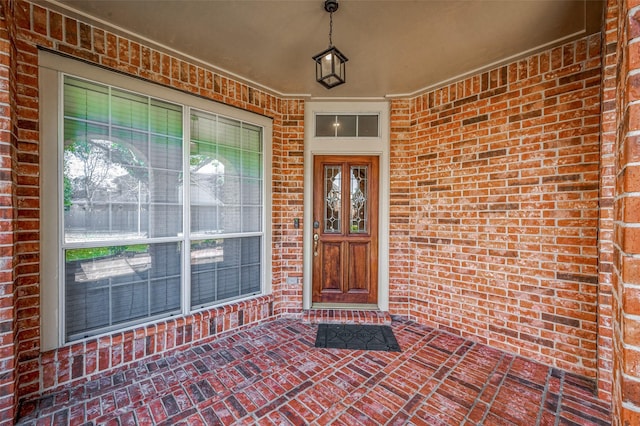 doorway to property with brick siding