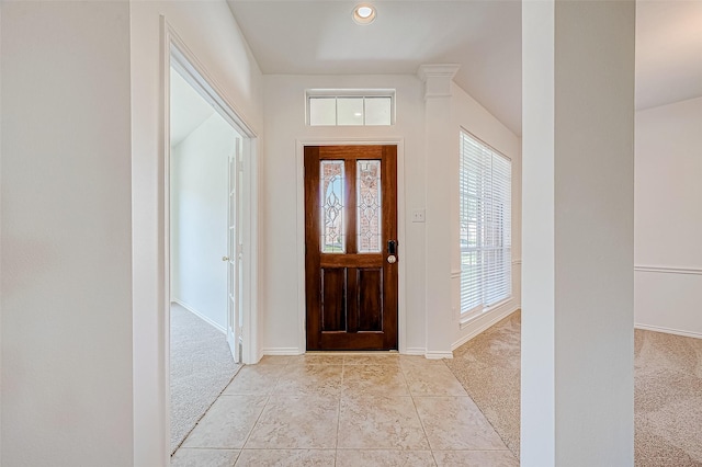 foyer entrance with light carpet