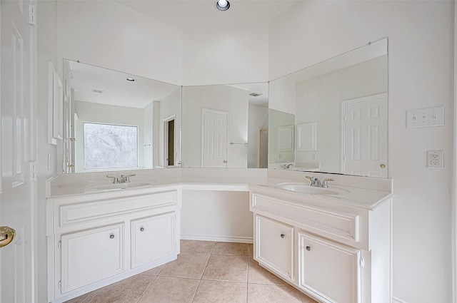 bathroom with a shower, tile patterned flooring, and vanity