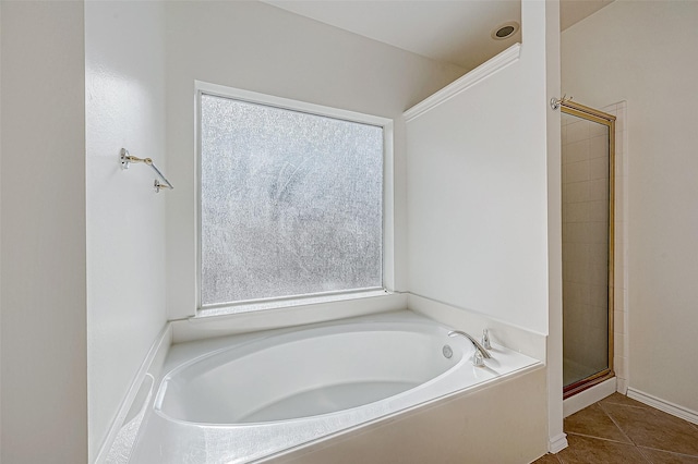 bathroom with tile patterned floors and independent shower and bath