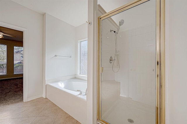 bathroom featuring tile patterned flooring, a shower stall, and a bath