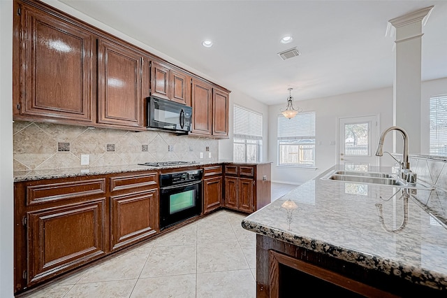 kitchen with visible vents, light tile patterned flooring, a sink, black appliances, and backsplash