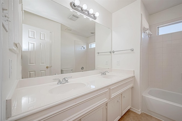 full bathroom with tile patterned floors, tiled shower / bath combo, toilet, and vanity