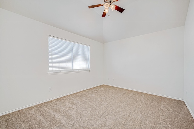 carpeted spare room featuring ceiling fan and lofted ceiling