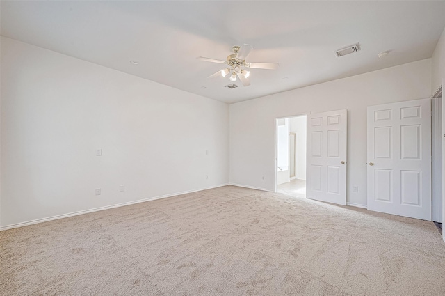 unfurnished room featuring ceiling fan and light carpet