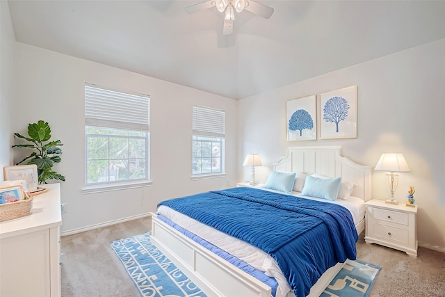 bedroom featuring ceiling fan, lofted ceiling, baseboards, and light carpet