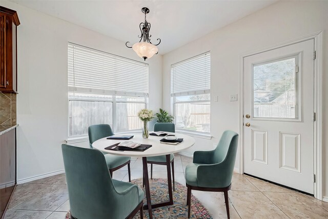 dining space with light tile patterned floors and baseboards