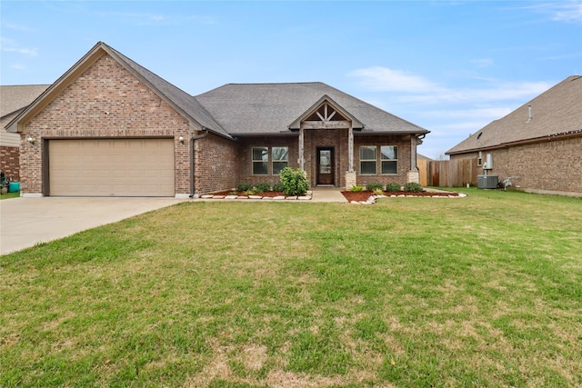 view of front of property with cooling unit, a front lawn, and a garage