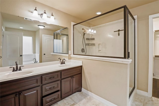 bathroom featuring tile patterned flooring, vanity, and a shower with door