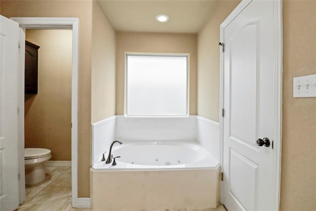 bathroom with a tub, tile patterned flooring, and toilet