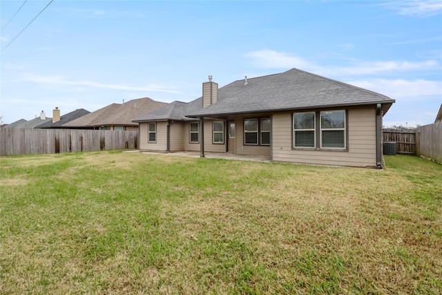 rear view of property with a patio, central air condition unit, and a lawn