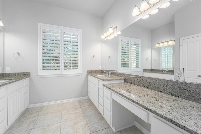 bathroom with tile patterned flooring and vanity