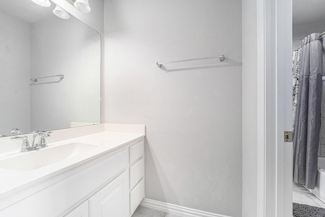 bathroom with shower / tub combo, vanity, and tile patterned floors