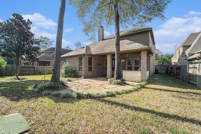 rear view of property with a patio area and a lawn