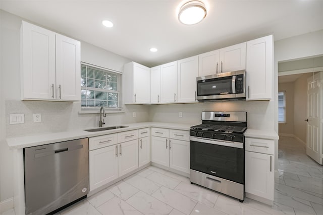 kitchen with white cabinets, sink, and appliances with stainless steel finishes