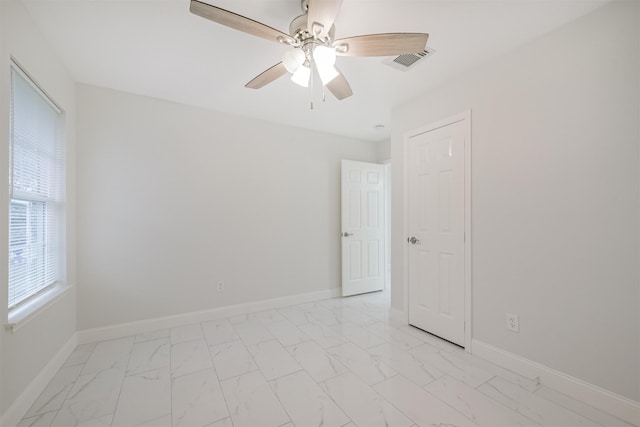 unfurnished room with ceiling fan