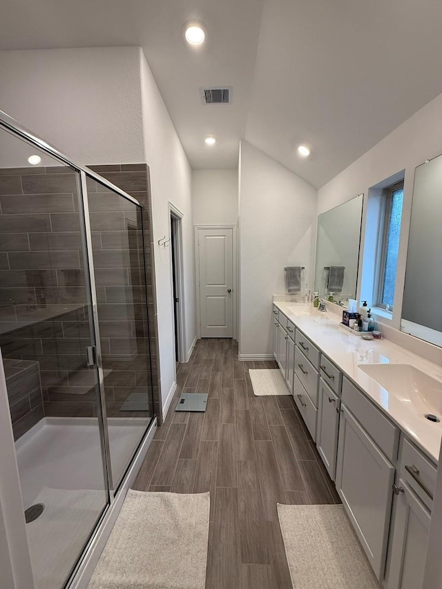 bathroom featuring vanity and an enclosed shower