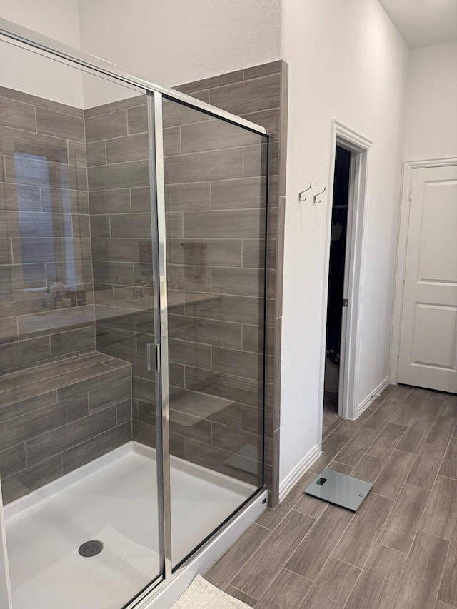 bathroom featuring a shower with door