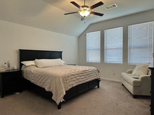 bedroom featuring ceiling fan, light carpet, and lofted ceiling