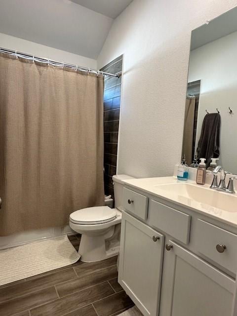 bathroom with a shower with shower curtain, vanity, toilet, and lofted ceiling