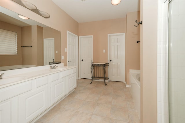 bathroom with a bathtub, vanity, and tile patterned flooring