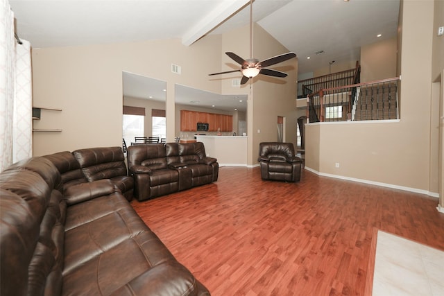 living room with beam ceiling, ceiling fan, high vaulted ceiling, and wood-type flooring