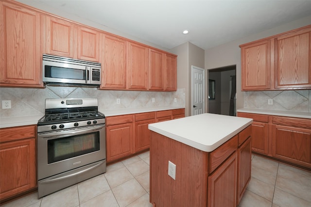 kitchen with a center island, light tile patterned flooring, stainless steel appliances, and tasteful backsplash