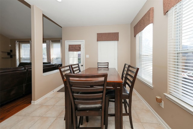 dining area with a wealth of natural light and light tile patterned floors