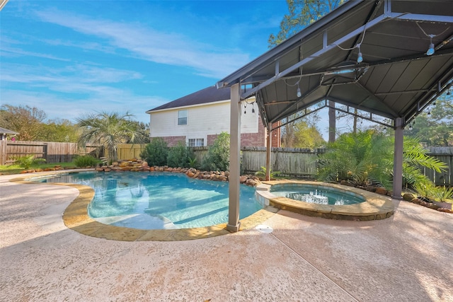 view of pool with an in ground hot tub