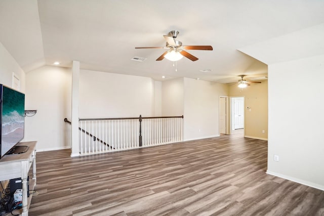 unfurnished living room with ceiling fan, hardwood / wood-style floors, and vaulted ceiling